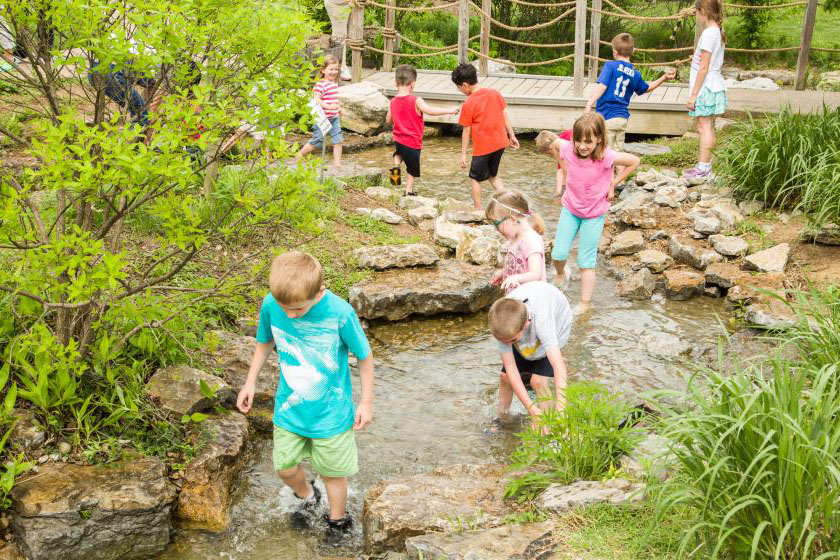 Children play in the water at the Kentucky Children's Garden